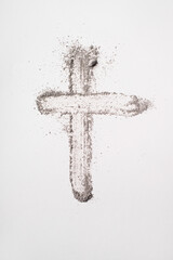 Ash cross symbol on white background for lent and religious reflection. Ash Wednesday