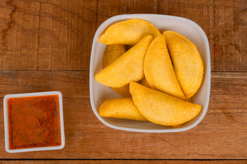 Delicious traditional Colombian empanadas with spicy sauce