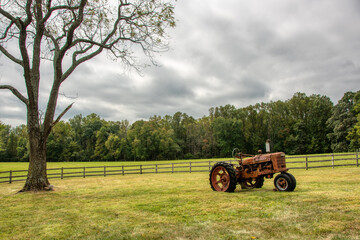 Old rusty tractor in a field.