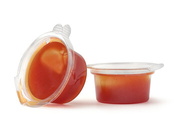 red sauce in small clear plastic containers which serve along with pizzas isolated white background, classic tomato based sauce used as dipping