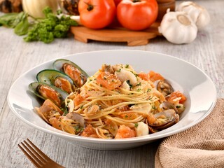 Seafood Spaghetti served in dish isolated on wooden table side view of italian fast food