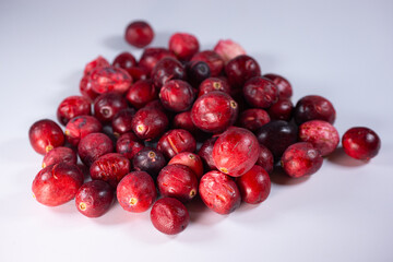 Close-up of freeze-dried cranberries, some whole and others halved, showcasing their vibrant red color and airy texture. Perfect for snacks, baking, or as a healthy topping.
