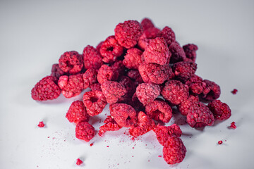 Close-up of freeze-dried raspberries showcasing their vibrant red color, natural texture, and crisp...
