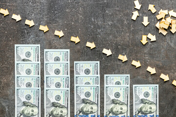 A descending scale made of $100 bills that symbolize market decline and recessions. financial concept