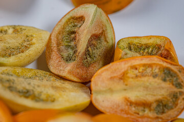 A vibrant collection of freeze-dried tomatoes in a mix of whole and sliced pieces. The rich textures and earthy tones highlight the preservation process.