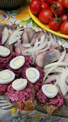 Herring with onions and egg on a festive table