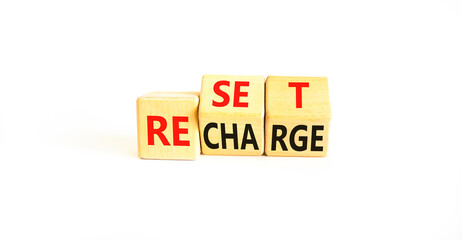 Reset and recharge symbol. Concept words Reset Recharge on beautiful wooden block. Beautiful white...