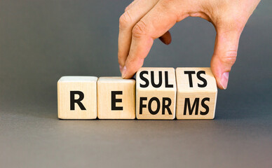 Reform and result symbol. Concept words Reforms Results on beautiful wooden block. Beautiful grey...