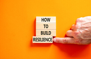 How to build resilience symbol. Concept words How to build resilience on beautiful wooden blocks. Beautiful orange table orange background. Business and how to build resilience concept. Copy space.
