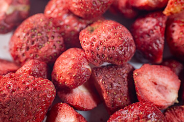 A detailed close-up of vibrant red freeze-dried strawberries, showcasing their texture and natural appeal. Perfect as a healthy snack or for culinary use.