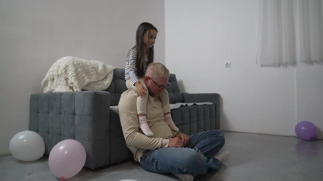 Girl, Father, Birthday Happy girl sitting on father's shoulders during birthday celebration. - Powered by Adobe