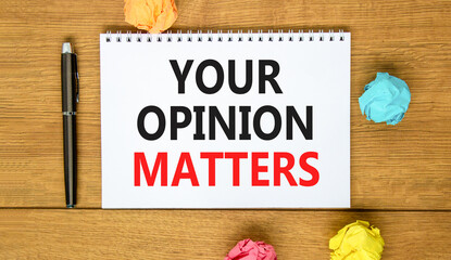 Fototapeta premium Your opinion matters symbol. Concept words Your opinion matters on beautiful white note. Beautiful wooden background. Black pen. Colored paper. Business your opinion matters concept. Copy space.