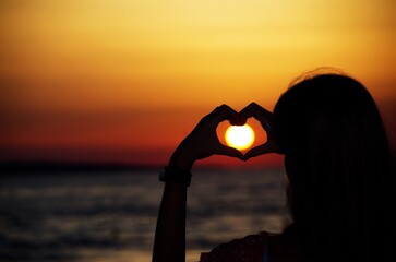 The young girl catches the sun in her heart