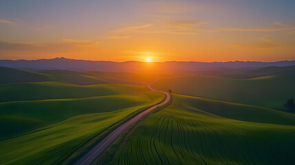 Fototapeta premium Road leading through a valley under the soft glow of sunset.