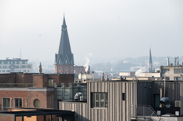 Naklejka premium Brick stone and renovated backside of apartment blocks with a church tower, high angle view in Brussels old town, Belgium
