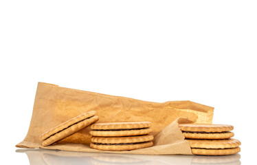 Several sweet delicious cookies on a paper bag, close-up, isolated on a white background.