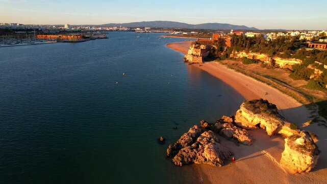 Portugal scenic places. Beach and castle Sao Joao do Arade in Ferragudo fishing village in the Algarve .  sunset scenery
