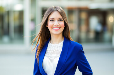 Fototapeta premium Smiling businesswoman posing in the city center