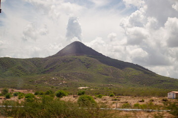 Inactive volcano in Brazil, with blue sky and clouds around it framing the landscape