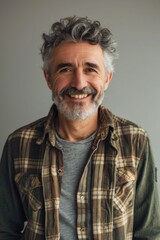 Fototapeta premium Elderly man in casual attire with a warm, engaging smile captured in a portrait