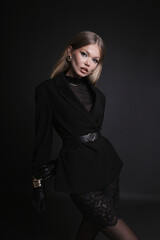 beautiful slavic woman with blond long hair wearing elegant clothes with accessories, posing in studio
