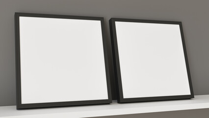 Two empty black frame resting on a white shelf against a gray wall. Ideal mockup for displaying artwork, photos, or posters. The scene creates a clean, minimalist, and modern aesthetic.