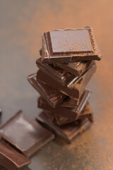 Broken dark chocolate and cocoa powder on a table