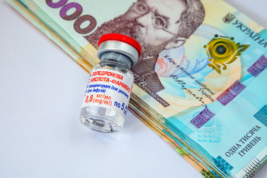 Kyiv. Ukraine. January 19, 2025. A bottle of zoledronic acid, a medicine for the treatment of oncology, on the background of money.