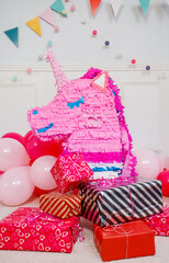 Colorful unicorn pinata and presents at the birthday party