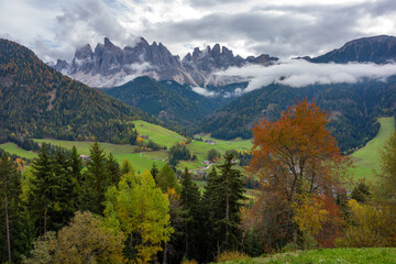The specular landscape when you drive at Val di Funes area in Autumn season, Dolomite, Italy.