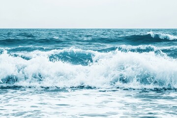 Fototapeta premium Ocean Waves Gradient: Waves crashing onto the shore with colors transitioning from deep navy blue to turquoise and white foam