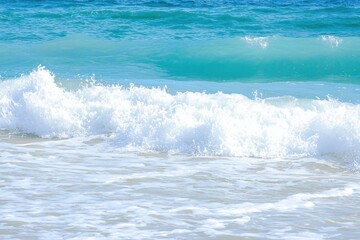Ocean Waves Gradient: Waves crashing onto the shore with colors transitioning from deep navy blue to turquoise and white foam