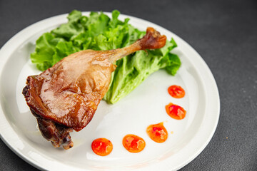 Duck leg confit baked bird meat fresh tasty food dish delicious gourmet food background on the table rustic food top view copy space