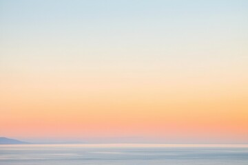 Fototapeta premium Sunset Gradient: A sky transitioning from deep orange to soft pink, with the horizon fading into a calm, dusky blue