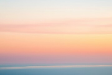 Fototapeta premium Sunset Gradient: A sky transitioning from deep orange to soft pink, with the horizon fading into a calm, dusky blue