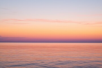 Fototapeta premium Sunset Gradient: A sky transitioning from deep orange to soft pink, with the horizon fading into a calm, dusky blue