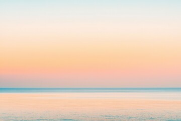 Fototapeta premium Sunset Gradient: A sky transitioning from deep orange to soft pink, with the horizon fading into a calm, dusky blue