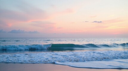 Obraz premium Serene ocean wave breaking gently on the shore at sunset, with a soft pink and pastel sky