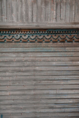 Weathered wooden panel with ornate carving details, perfect for rustic vintage design