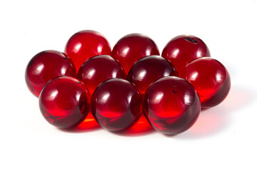 A bunch of red glass balls are sitting on a white background
