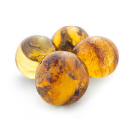 Four amber colored stones are sitting on a white background