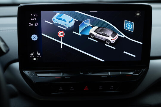 The display of an electric car, where you can select assistants to assist the driver in movement in the menu. Assistant selection menu. Assistants for safe driving on electric vehicles