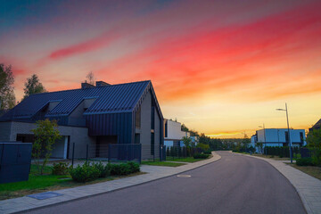 Barn house on sunset. Street road on sunset at Suburban Scandi home. Contemporary barnhouse. Barn...