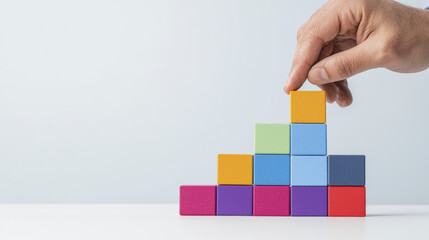 Building colorful pyramid with blocks, showcasing creativity and focus