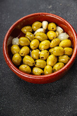 Olives mediterranean with garlic snack aperitif fresh tasty food dish  gourmet food background on the table rustic food top view copy space keto and paleo diet Vegetarian and vegan food