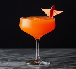 A paper plane made from an orange bourbon cocktail served on a black background