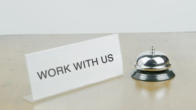 Work With Us Office or Room with Hand Ringing The Bell on Desk or Table Multiple Times