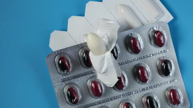 Rectal suppositories, opened package and Pills for treatment of erectile dysfunction, frequent urination and prostate adenoma, close-up. 4K video, rotating.