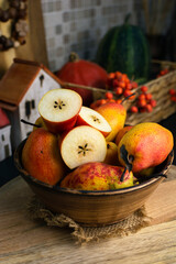 RED WILLIAM PEARS whole fruit and cut in half in a bowle. Known for its stunning deep red skin and soft, buttery texture. These sweet pears have red freckles, reminiscent of a Rainbow trout's skin
