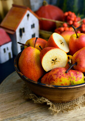 RED WILLIAM PEARS whole fruit and cut in half in a bowle. Known for its stunning deep red skin and soft, buttery texture. These sweet pears have red freckles, reminiscent of a Rainbow trout's skin